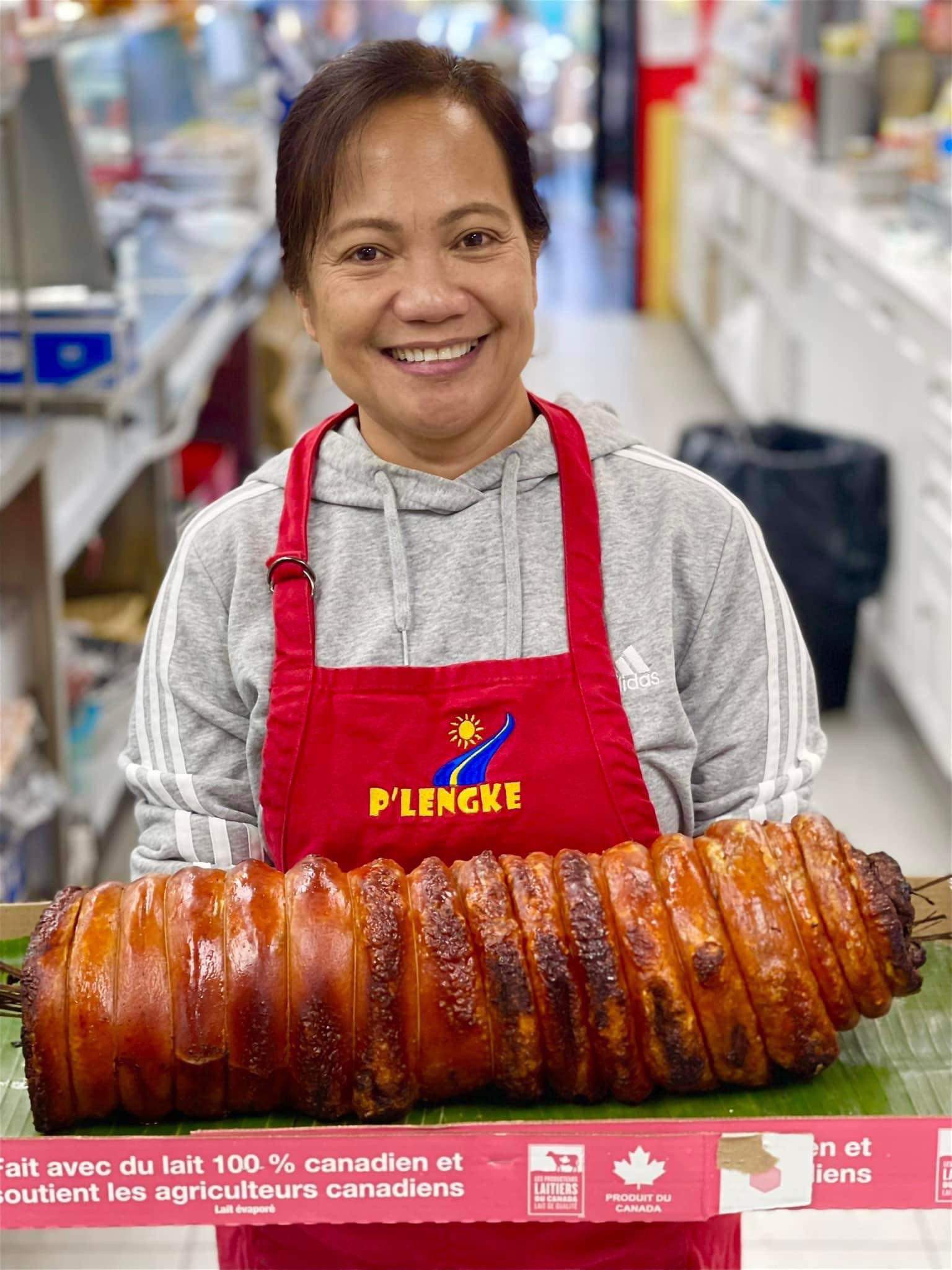 Chef proudly presenting large lechon roll